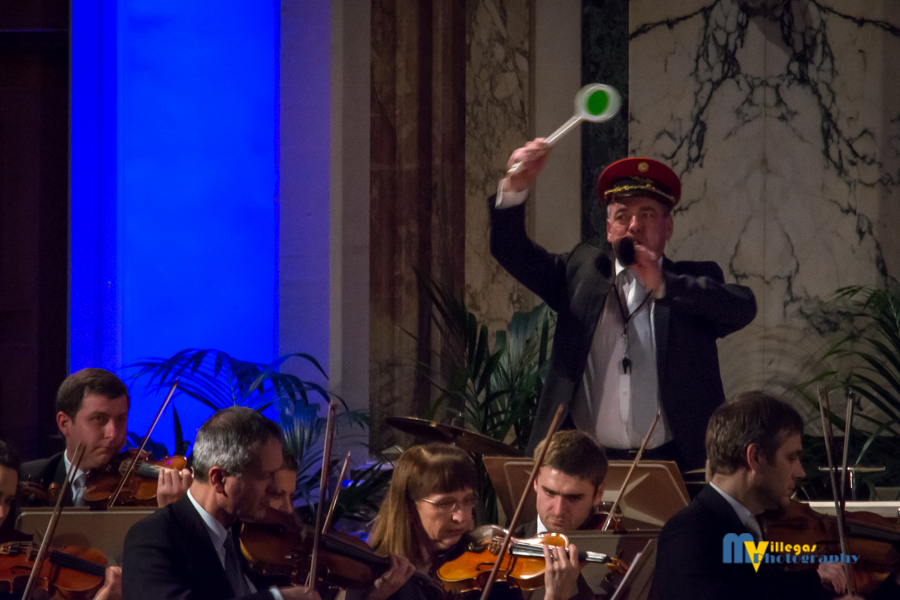 Visual and comedic aspects to the performance, the percussionist becomes a train conductor.